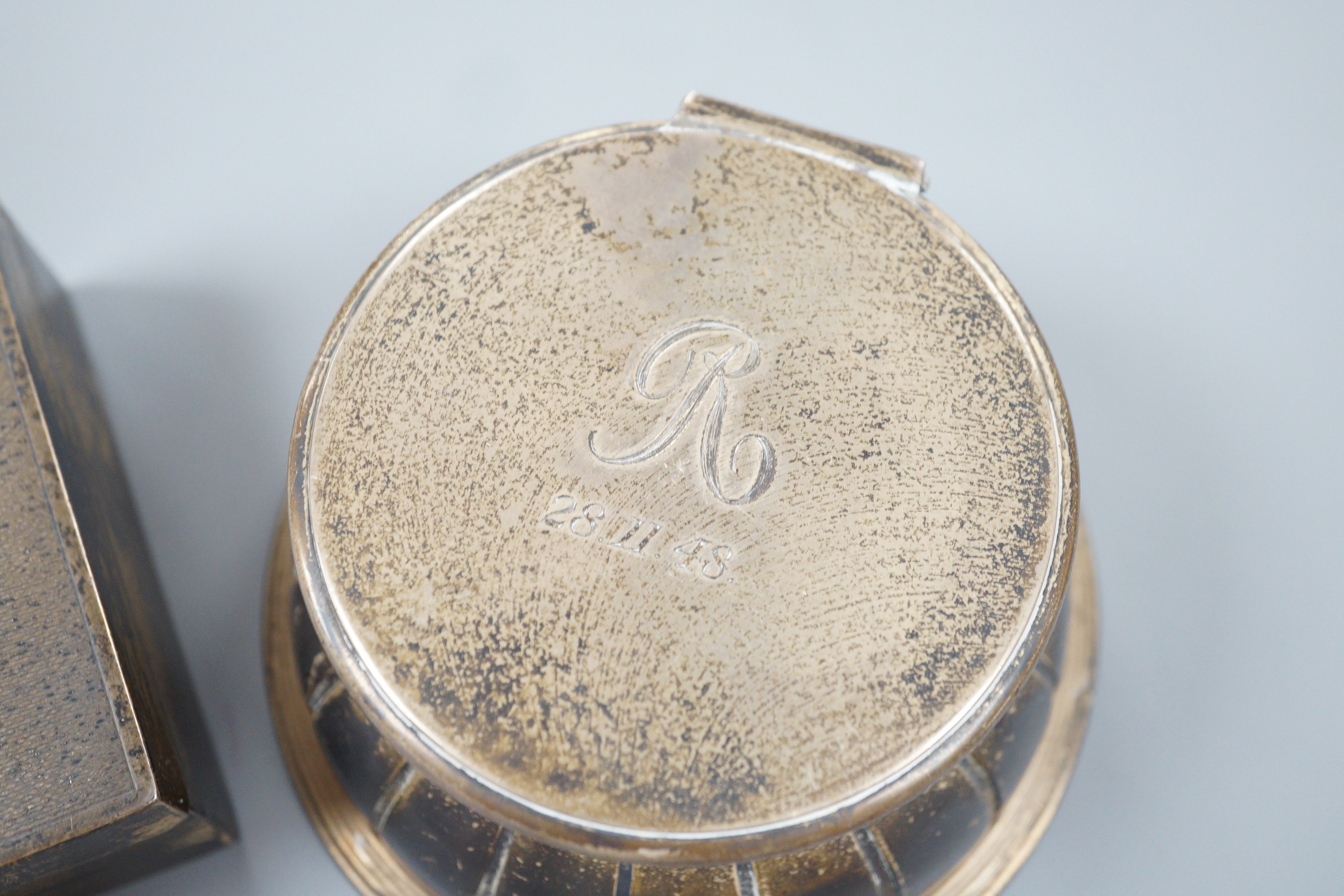 An Edwardian silver mounted circular glass inkwell by George Fox, London, 1901, diameter 11.3cm and a later silver mounted cigarette box.